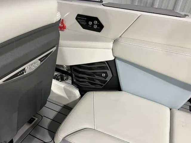 Slide: The Image of Interior of 2025 Nautique Super Air Nautique G25 boat with white seating and speaker. - 22