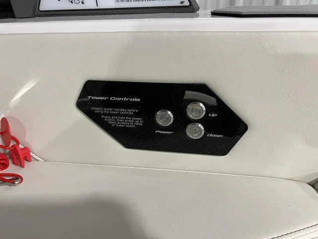 Slide: The Image of 2025 Nautique Super Air Nautique G25 tower controls with power, up, and down buttons. - 23