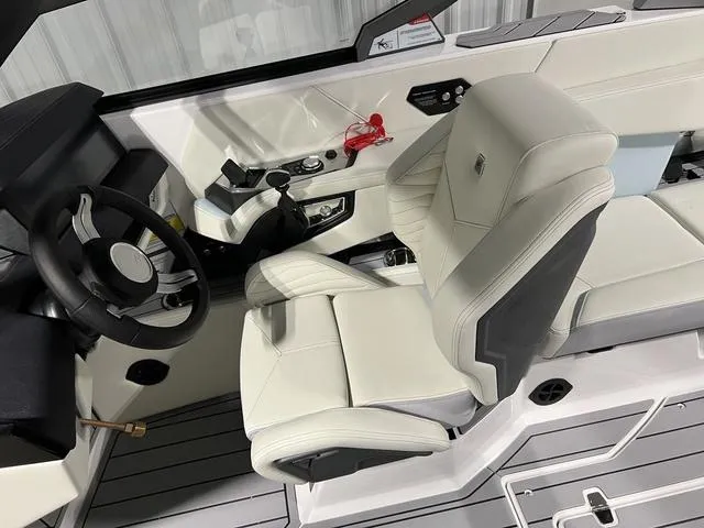 Slide: The Image of 2025 Nautique Super Air Nautique G25 cockpit with sleek white seating and modern controls. - 25