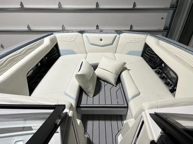 Slide: The Image of 2025 Nautique Super Air Nautique G25 interior with plush seating and cushions. - 30