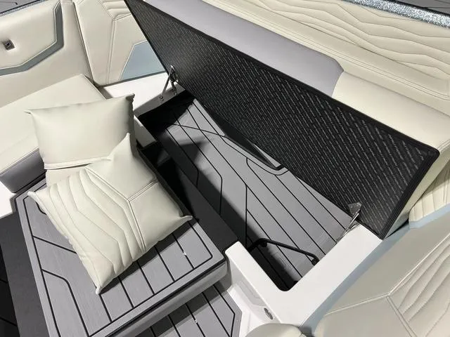 Slide: The Image of 2025 Nautique Super Air Nautique G25 interior with open storage and cushioned seating. - 32