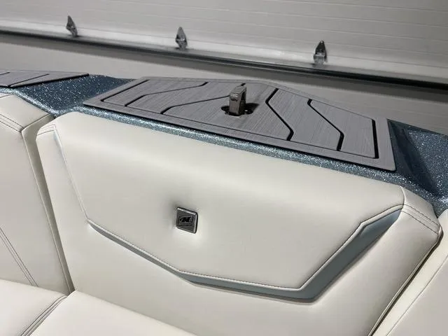 Slide: The Image of 2025 Nautique Super Air Nautique G25 interior with sleek white upholstery and modern design. - 33