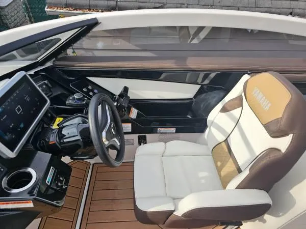 Slide: The Image of 2023 Yamaha Boats 275 SDX cockpit with modern steering and comfortable seating. - 11