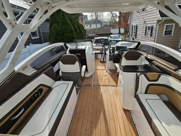 Slide: The Image of 2023 Yamaha Boats 275 SDX interior with luxurious seating and sleek design. - 12