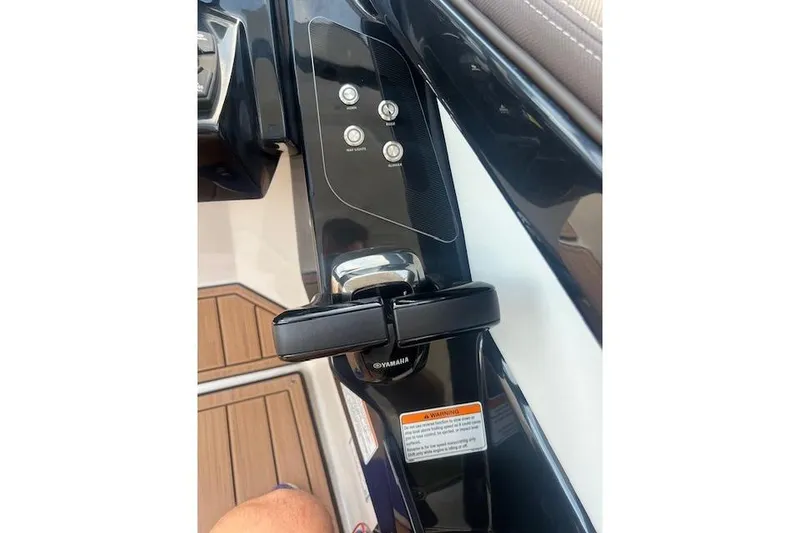 Slide: The Image of Control panel of 2023 Yamaha Boats 275SDX with buttons and throttle lever. - 18