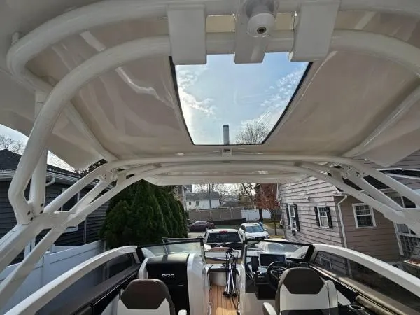 Slide: The Image of 2023 Yamaha Boats 275 SDX interior with open sunroof, showcasing modern design and seating. - 22