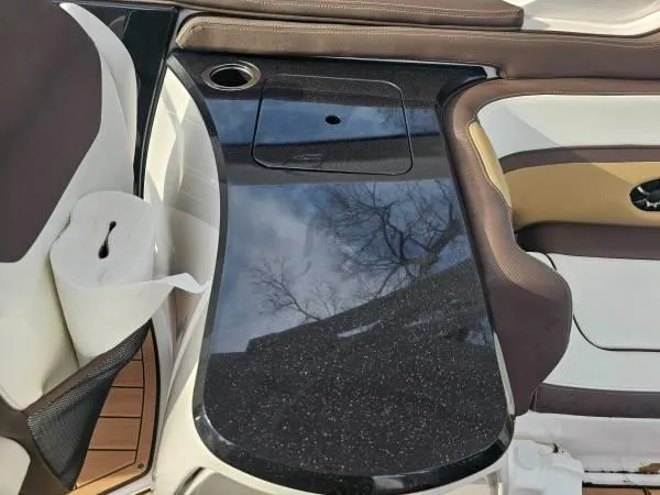 Slide: The Image of 2023 Yamaha Boats 275 SDX interior with sleek black table and seating. - 26