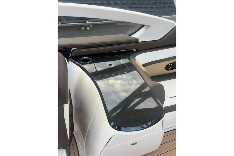 Slide: The Image of 2023 Yamaha Boats 275SDX interior with sleek black countertop and cup holder. - 27