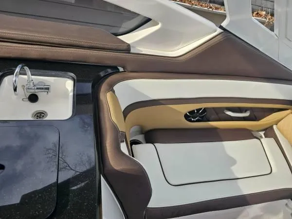 Slide: The Image of Interior of 2023 Yamaha Boats 275 SDX, featuring sleek seating and a compact sink. - 29