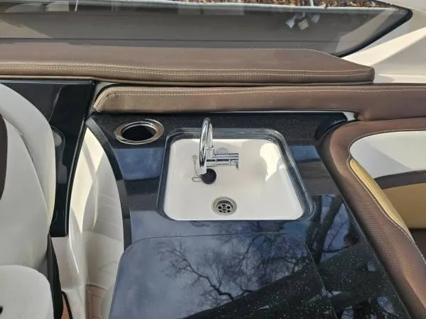 Slide: The Image of 2023 Yamaha Boats 275 SDX interior with sink and seating area. - 30