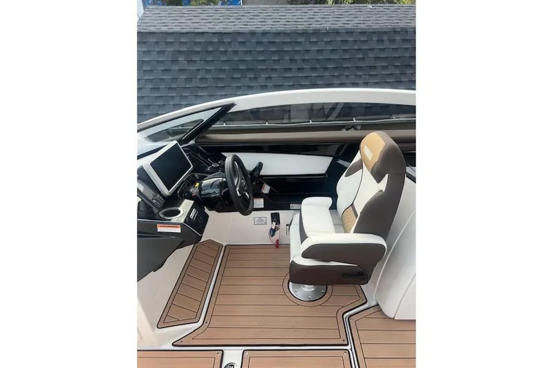 Slide: The Image of 2023 Yamaha Boats 275SDX cockpit with modern controls and comfortable seating. - 32