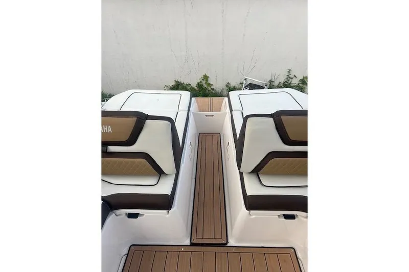 Slide: The Image of 2023 Yamaha Boats 275SDX interior with sleek seating and wooden flooring. - 33