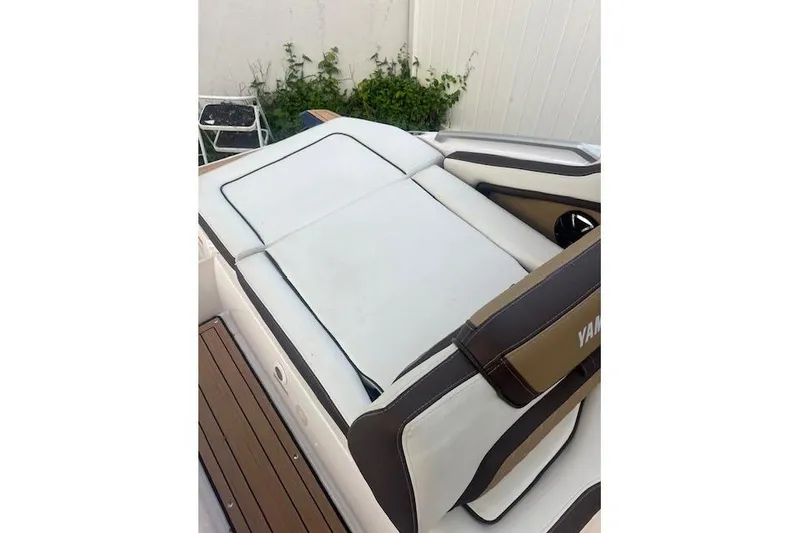 Slide: The Image of 2023 Yamaha Boats 275SDX interior seating with white and brown upholstery. - 35