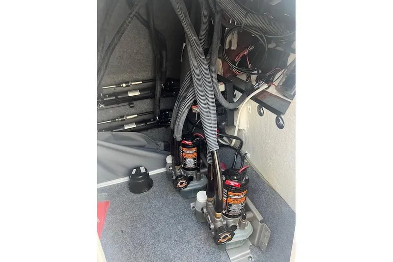 Slide: The Image of 2023 Yamaha Boats 275SDX engine compartment with hydraulic components and wiring. - 37