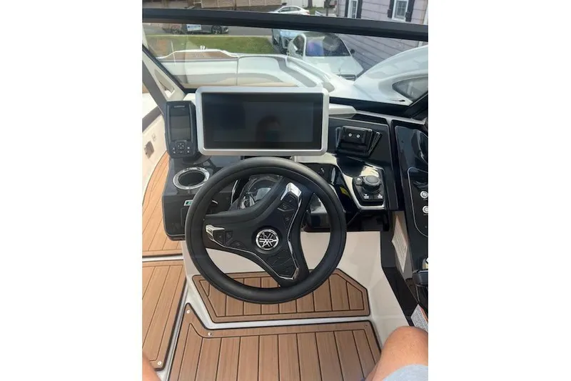 Slide: The Image of 2023 Yamaha Boats 275SDX helm with steering wheel, touchscreen, and control panel. - 9