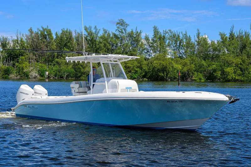 Slide: The Image of 2023 Powerplay Powerboats 30 RumRunner cruising on a serene lake. - 10