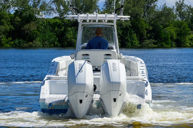 Slide: The Image of 2023 Powerplay Powerboats 30 RumRunner cruising on a serene lake. - 12