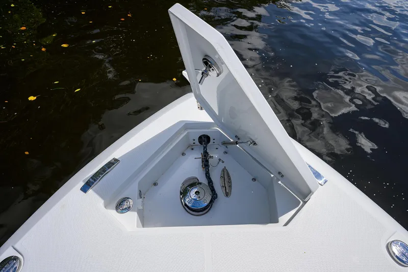 Slide: The Image of 2023 Powerplay Powerboats 30 RumRunner anchor compartment open on calm water. - 13
