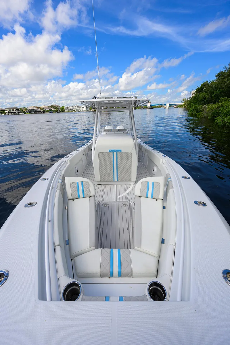 Slide: The Image of 2023 Powerplay Powerboats 30 RumRunner on calm water under blue sky. - 14