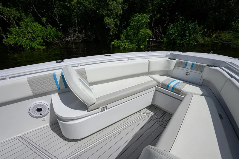 Slide: The Image of 2023 Powerplay Powerboats 30 RumRunner interior with white seating and blue accents. - 15