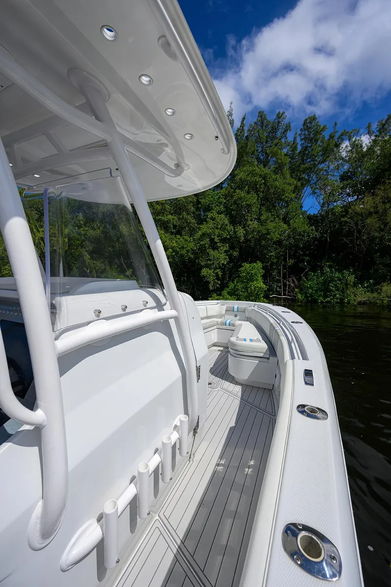 Slide: The Image of 2023 Powerplay Powerboats 30 RumRunner on a serene river, surrounded by lush greenery. - 18