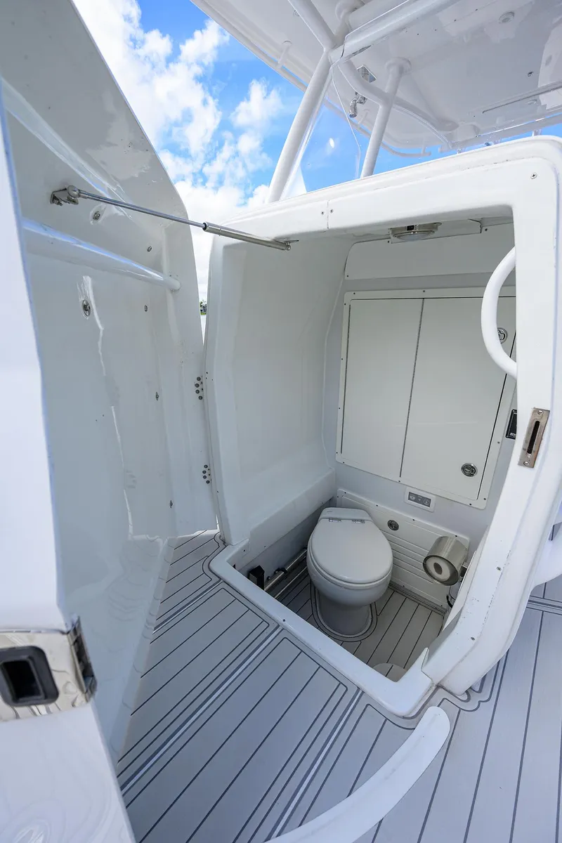 Slide: The Image of 2023 Powerplay Powerboats 30 RumRunner bathroom interior with modern amenities. - 19