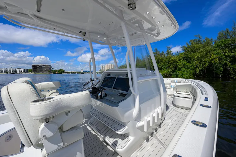 Slide: The Image of 2023 Powerplay Powerboats 30 RumRunner on serene water, featuring sleek design and modern controls. - 22