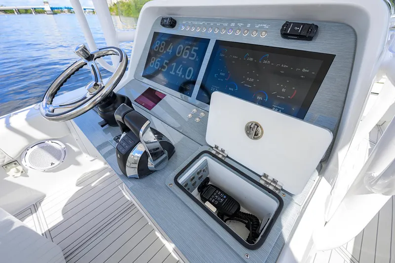 Slide: The Image of 2023 Powerplay Powerboats 30 RumRunner dashboard with modern controls and navigation system. - 23