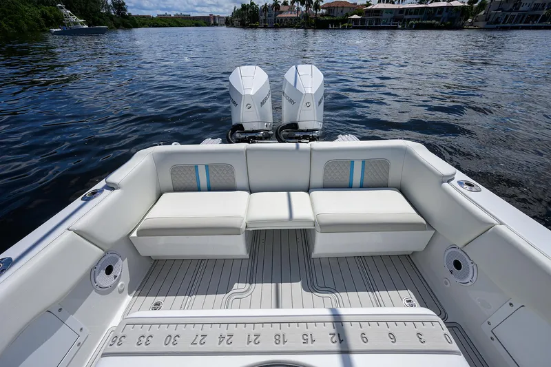 Slide: The Image of 2023 Powerplay Powerboats 30 RumRunner with dual engines on a serene lake. - 28