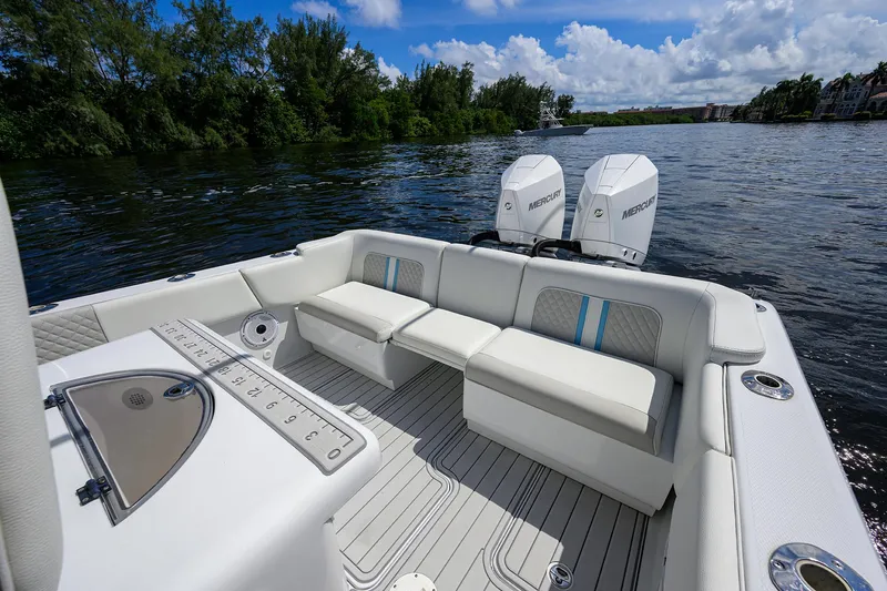 Slide: The Image of 2023 Powerplay Powerboats 30 RumRunner on a scenic river with plush seating. - 29