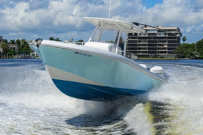 Slide: The Image of 2023 Powerplay Powerboats 30 RumRunner speeding on water, showcasing sleek design and performance. - 3
