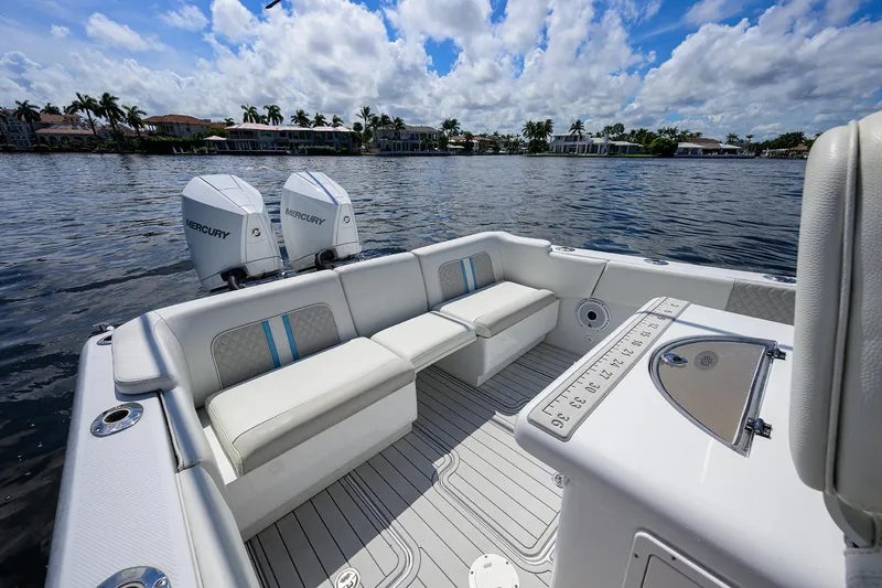 Slide: The Image of 2023 Powerplay Powerboats 30 RumRunner on water, featuring spacious seating and dual Mercury engines. - 30