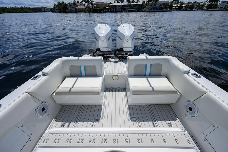 Slide: The Image of 2023 Powerplay Powerboats 30 RumRunner with twin engines on a calm lake. - 31