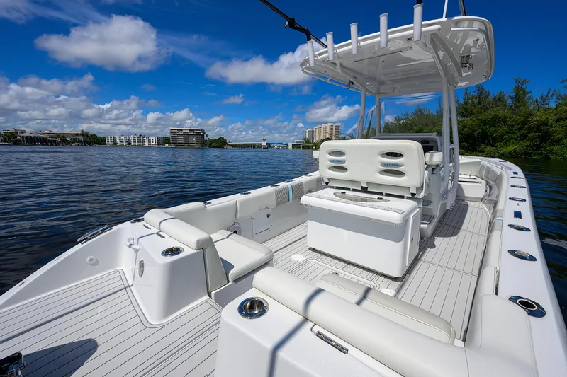 Slide: The Image of 2023 Powerplay Powerboats 30 RumRunner on scenic waterway, featuring sleek white deck design. - 32