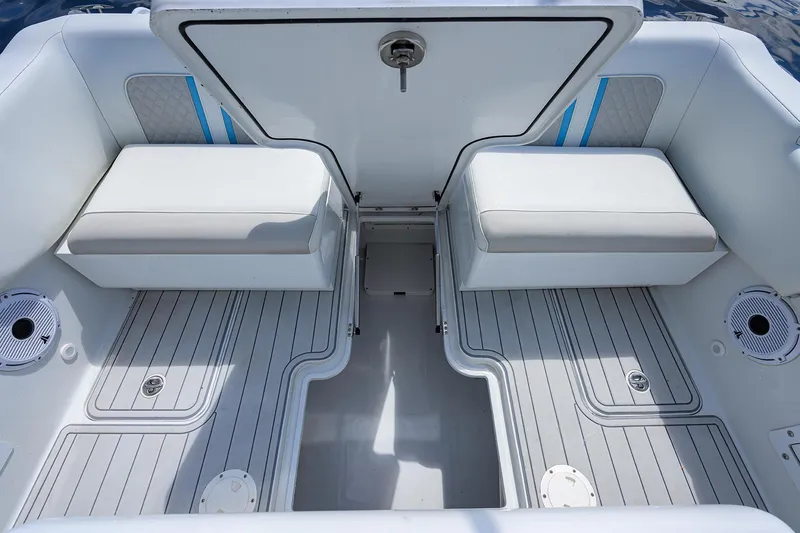 Slide: The Image of 2023 Powerplay Powerboats 30 RumRunner interior with cushioned seating and sleek design. - 36