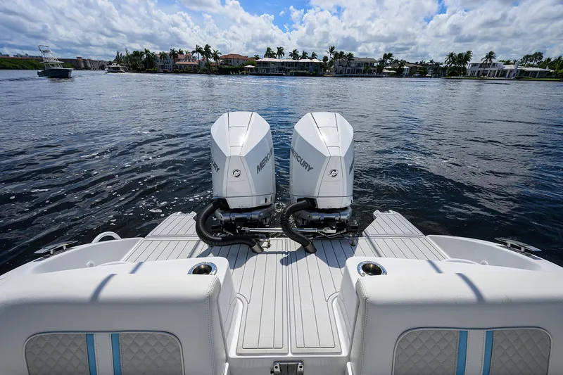 Slide: The Image of 2023 Powerplay Powerboats 30 RumRunner with twin engines on a calm lake. - 38