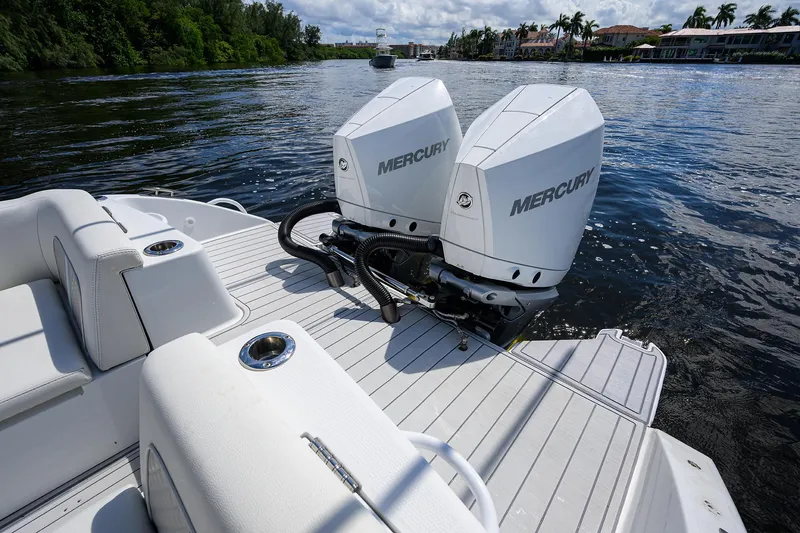 Slide: The Image of 2023 Powerplay Powerboats 30 RumRunner with twin Mercury engines on a serene waterway. - 39