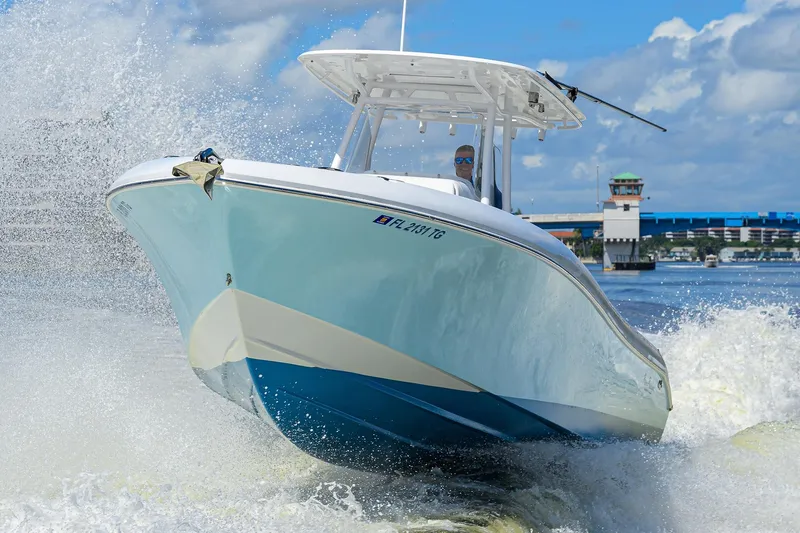 Slide: The Image of 2023 Powerplay Powerboats 30 RumRunner cruising on water, creating dynamic waves. - 4