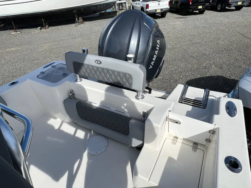 Slide: The Image of 2025 Defiance Catalina 240 boat with Yamaha outboard motor, rear seating area. - 16