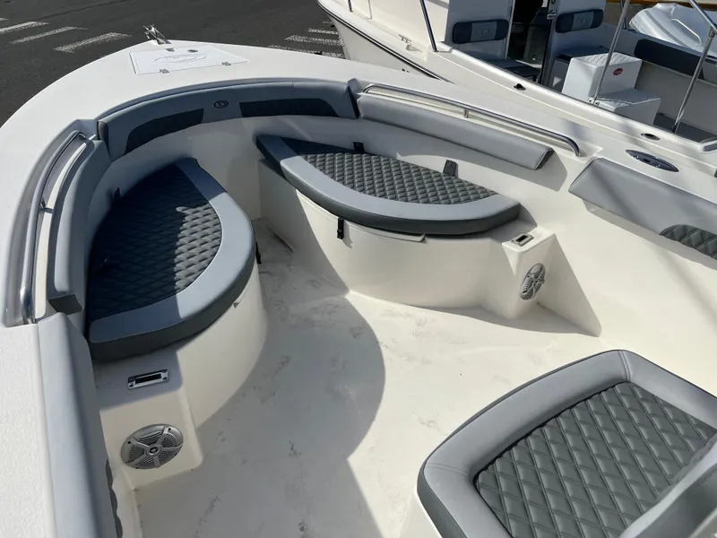 Slide: The Image of 2025 Defiance Catalina 240 boat interior with cushioned seating and speakers. - 18
