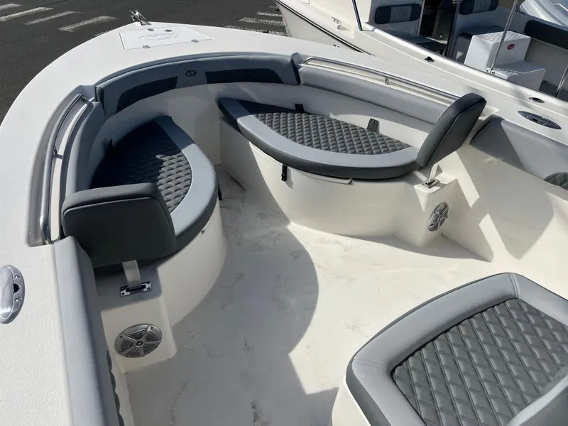 Slide: The Image of 2025 Defiance Catalina 240 boat interior with cushioned seating and speakers. - 19