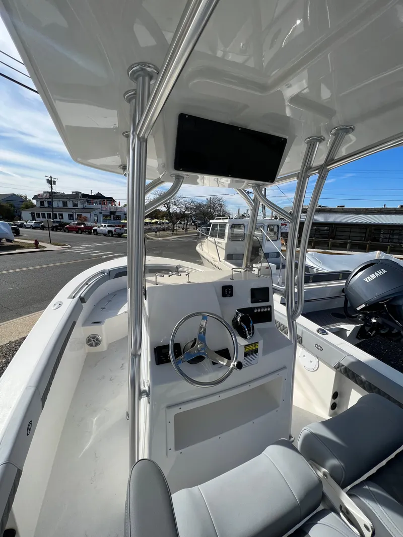 Slide: The Image of 2025 Defiance Catalina 240 boat interior with steering wheel and console. - 24
