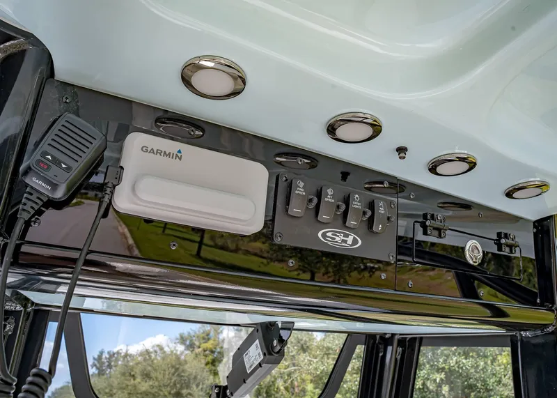 Slide: The Image of 2025 Sea Hunt BX 25 FS boat dashboard with Garmin electronics and control switches. - 11