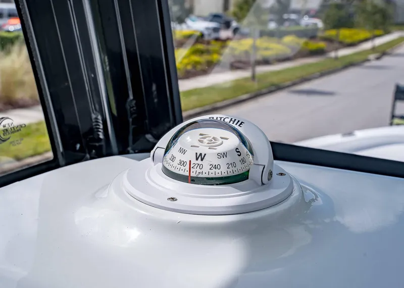 Slide: The Image of Compass on 2025 Sea Hunt BX 25 FS boat dashboard, showing west direction. - 14