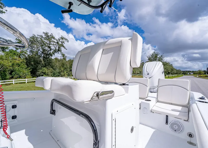 Slide: The Image of 2025 Sea Hunt BX 25 FS boat interior with white seating and clear sky background. - 23