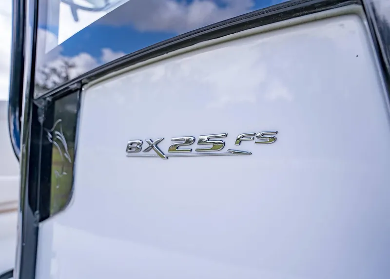 Slide: The Image of 2025 Sea Hunt BX 25 FS boat emblem on white surface. - 24