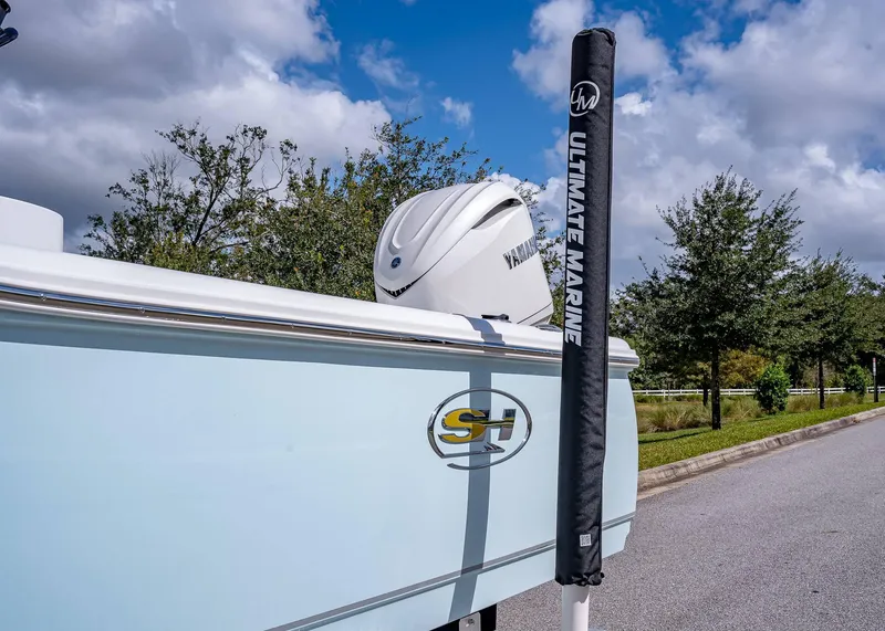 Slide: The Image of 2025 Sea Hunt BX 25 FS boat with Yamaha engine, parked on a sunny day. - 5