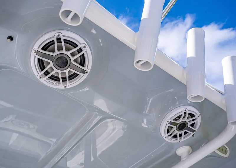 Slide: The Image of JL Audio speakers on 2025 Sea Hunt Ultra 255 SE boat, under blue sky. - 10