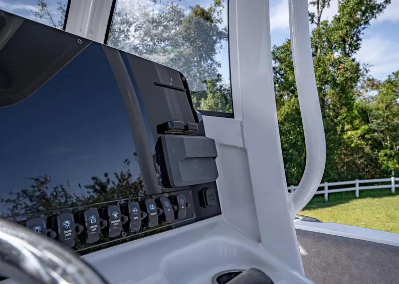 Slide: The Image of 2025 Sea Hunt Ultra 255 SE dashboard with control panel and steering wheel. - 11