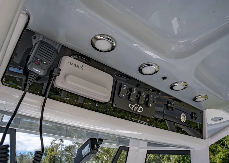 Slide: The Image of 2025 Sea Hunt Ultra 255 SE boat console with Garmin equipment and controls. - 12